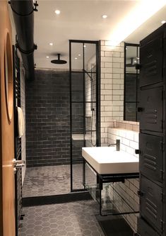 a bathroom with black and white tiled walls