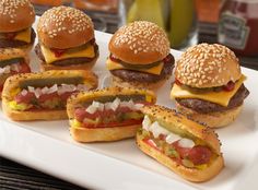 mini hamburgers are arranged on a white platter