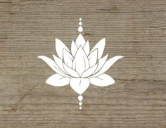 a white lotus flower sitting on top of a wooden table