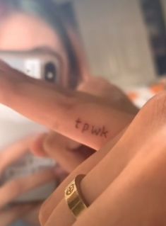 a woman pointing at her finger with the word twp written on it in cursive writing