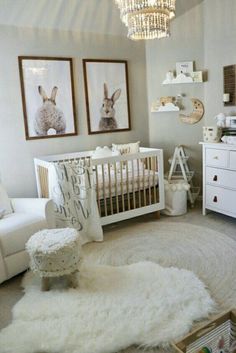 a baby's room with white furniture and pictures on the wall