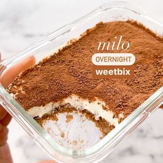 a person holding up a container with food in it that says nilo overnight weetbix