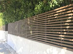 a white fence with black slats on it