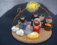 a nativity scene with figurines in the shape of people and a star