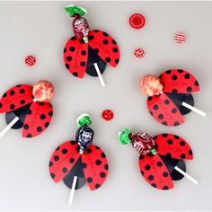 four ladybug lollipops are sitting on top of each other with candy