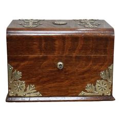 an old wooden box with metal decorations on it's sides and the lid open