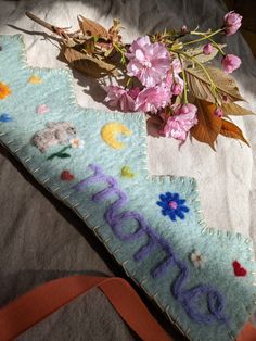 a close up of a piece of cloth with flowers on it and the word embroidery next to it