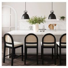 a kitchen table with four chairs and a plant in the center on top of it