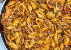 a skillet filled with pasta and meat sauce