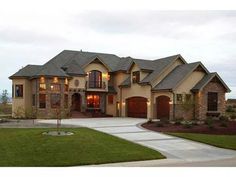 a large house with two car garages and lots of windows in front of it