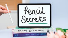 a person holding a pen and pointing to a sign that says pencil secrets on it