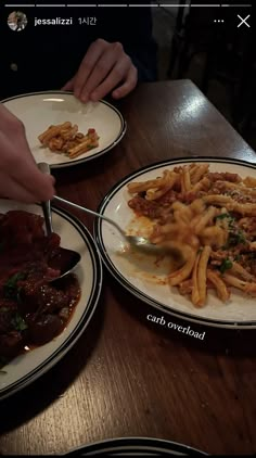 two plates with food on them sitting on a table next to another plate full of food