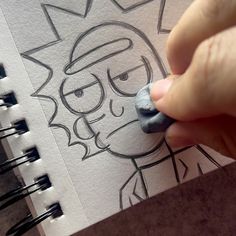 a person drawing on paper with a marker