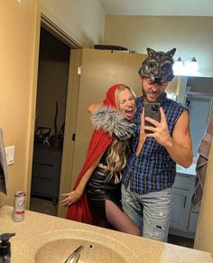 a man and woman in costumes taking a selfie