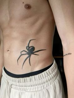 a man with a spider tattoo on his stomach