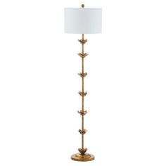 an antique brass floor lamp with a white shade