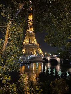 the eiffel tower is lit up at night