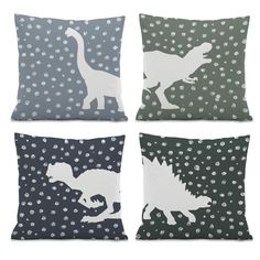 four pillows with dinosaurs on them in different colors and sizes, one is white and the other has grey dots