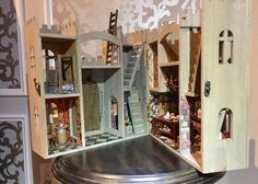 a doll house with stairs and furniture inside