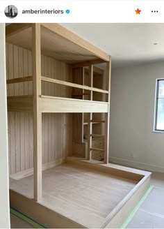 an empty room with bunk beds in the middle and no mattresses on the bottom