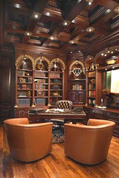 a living room filled with lots of furniture and bookshelves on top of hard wood flooring