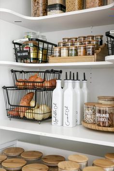 an open pantry with bread, milk and other items on the shelves in front of it