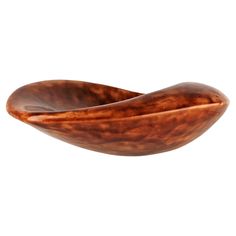 a wooden bowl sitting on top of a white surface