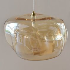 a clear glass light fixture hanging from a ceiling