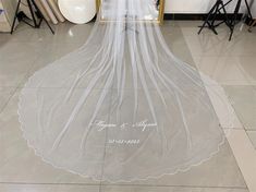 the bride's veil is hanging in front of a mirror