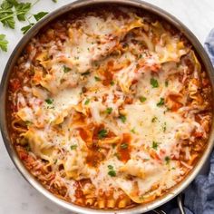 a large pot filled with lasagna sauce and cheese