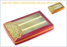 an open red box with gold trimmings and decorative designs on the lid, sitting next to a white background