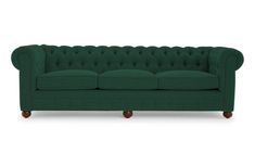 a green couch sitting on top of a white floor