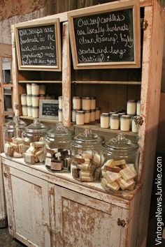 an old wooden cabinet filled with lots of different types of cheeses and marshmallows