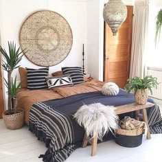 a bed room with a neatly made bed and plants