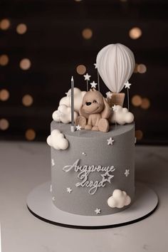 a birthday cake decorated with a teddy bear and hot air balloon