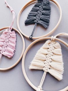 three different types of handmade ornaments on wooden hoop