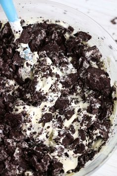 a glass bowl filled with ice cream and chocolate chip cookie cookies on top of it