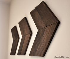 three pieces of wood are hanging on the wall