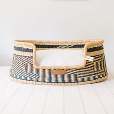 a blue and white basket sitting on top of a table