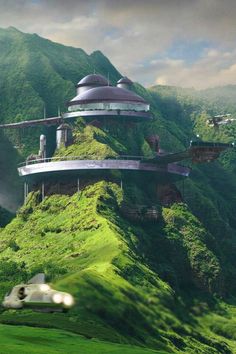 an artistic rendering of some futuristic buildings on a mountain side with green grass and mountains in the background