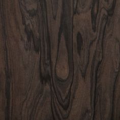 closeup of the wood grains on this wooden paneled wall, showing dark brown tones