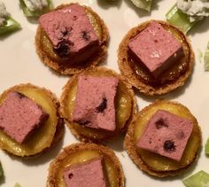 small pastries are arranged on a plate with lettuce and other food items