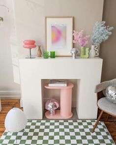 a living room filled with furniture and decor on top of a checkerboard floor