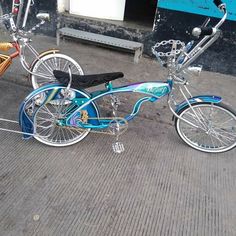 two bicycles parked next to each other on the street