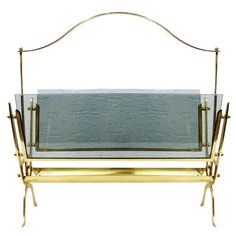 a metal and glass shelf with two shelves on one side, against a white background