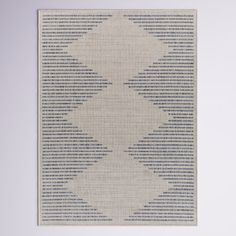 a white and blue rug hanging on the wall