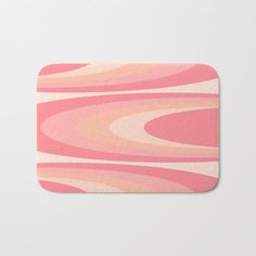 a pink and orange abstract design bath mat