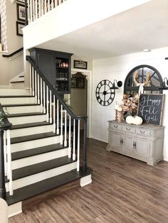 the stairs in this home are decorated with black and white decor, including pumpkins