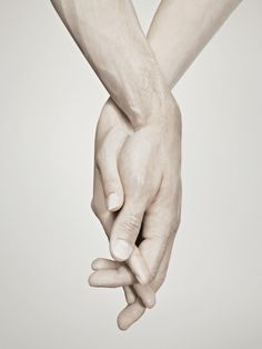 two hands holding each other in front of a white background with the words hebrew written on it