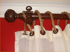 a curtain with rope hanging from it's end and an anchor on the top